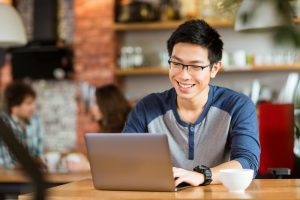 shutterstock man on laptop in cafe