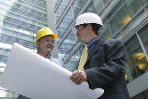 Architect and foreman in front of a building