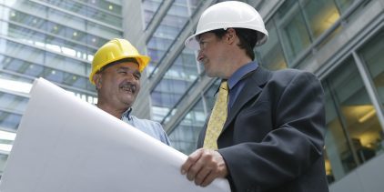 Architect and foreman in front of a building