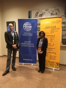 Nick and Tharindu standing next to the conference banners