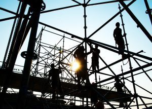 People in shadow on scaffolding