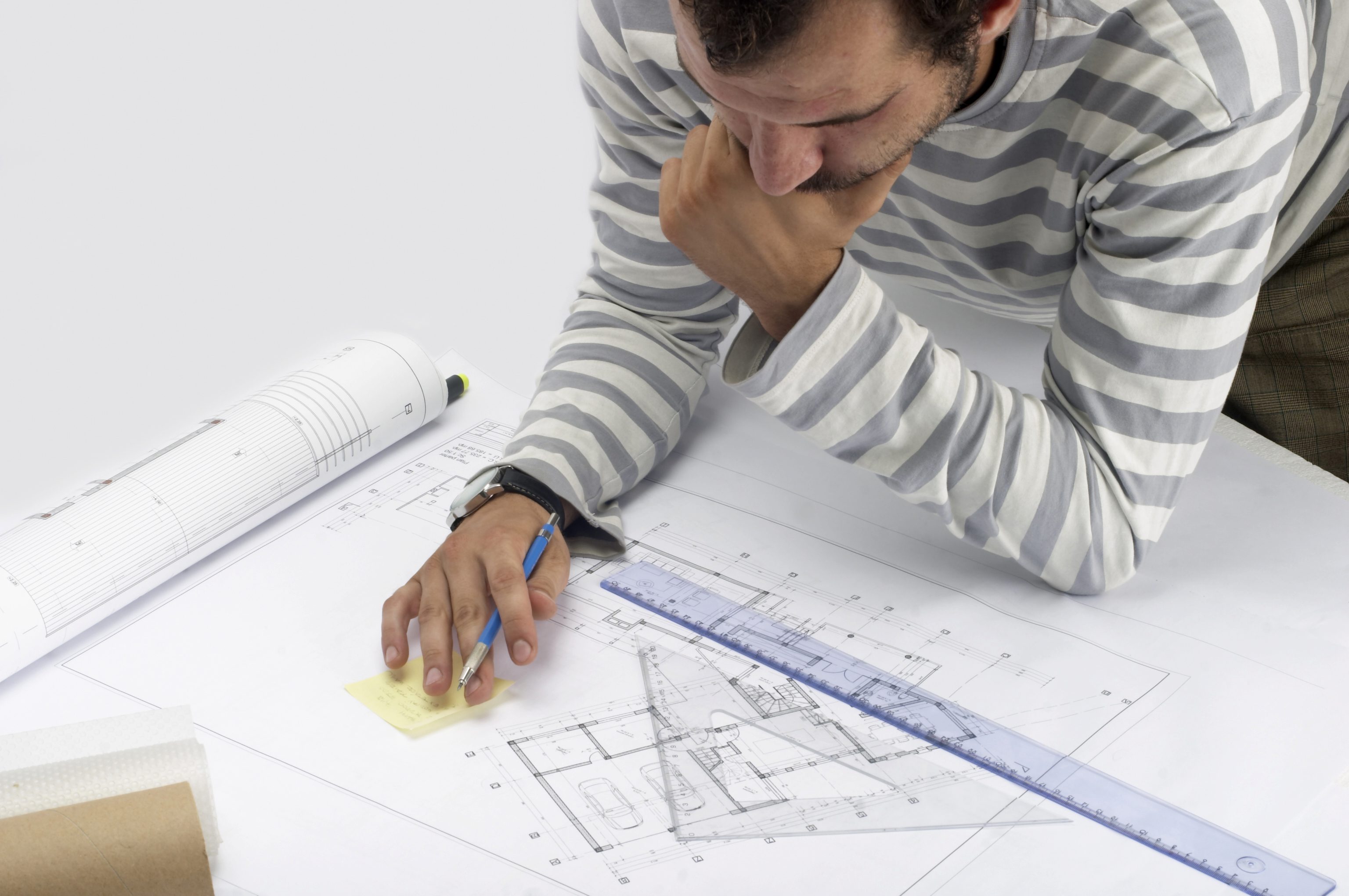 A man poring over architectural floor plans