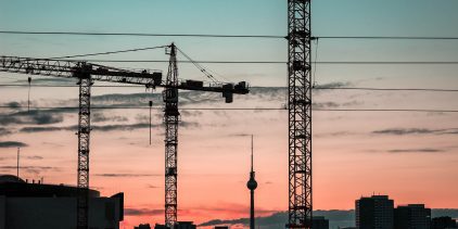 Cranes against a sunset