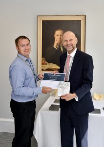 Andy receiving his certificate from Ashley