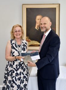 Janet receiving her certificate from Ashley