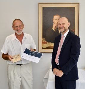 Gordon receiving his certificate from Ashley