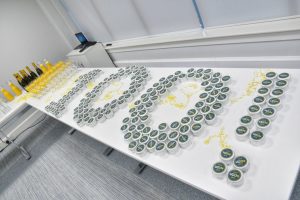 A table with a centenary cupcake selection in the shape of a '100!' alongside glasses of champagne