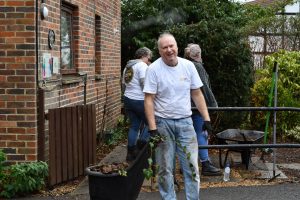 Staff member holding a branch in the Purley Park garden