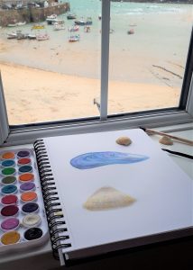 A watercolour painting in progress of seashells