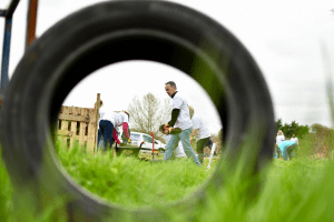 View of staff digging through a car tyre