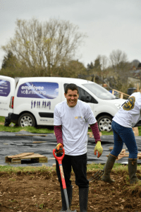 Staff members laughing whilst digging