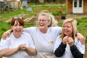 Staff members laughing whilst digging