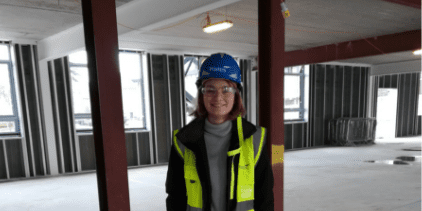 Phoebe in safety jacket and hard hat before her tour