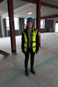 Phoebe in safety jacket and hard hat before her tour