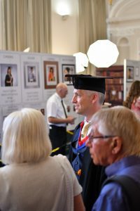 A recent graduate along with members of the public in the Reading Town Hall