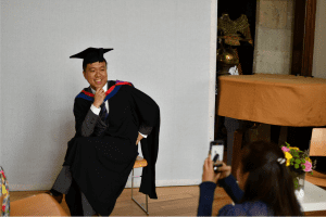 A recent graduate having his photo taken in Reading Town Hall