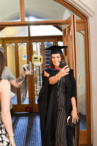 A recent graduate taking a selfie in Reading Town Hall