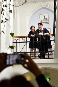 Two recent graduates having their picture taken in Reading Town Hall