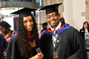 Two recent graduates in the Reading Town Hall soon after the UCEM graduation ceremony