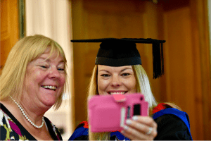 A recent graduate taking a selfie with her mum in the Reading Town Hall