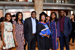 A recent graduate with her family/friends soon after the UCEM graduation ceremony that took place in Reading Town Hall