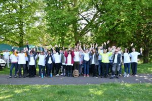 All 50 members of staff at Courage Park with their hands up