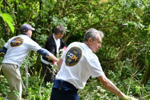 Members of staff digging at Courage Park