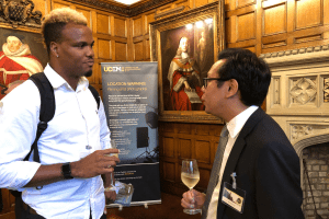 Two attendees enjoy a glass of champagne