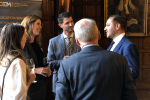 A group of students and alumni chatting over drinks