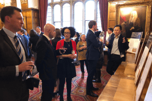 People talking and looking at the exhibits at our Projects for Good Exhibition