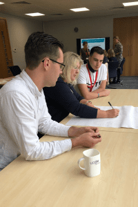 The second group working on a drawing of a modern student