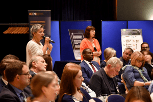 A member of the audience asking a question of the panel