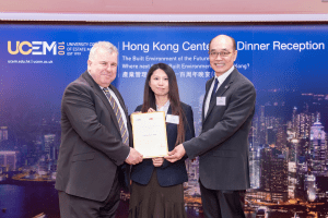 UCEM Dean of the Built Environment, Tim Bennett, presents a scholarship to a CityU student and a representative from the university