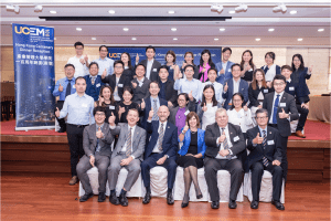 Senior UCEM staff members pose with thumbs-up alongside representatives from one of UCEM's partner bodies in Hong Kong