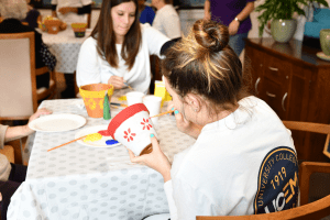 Volunteers painting flowerpots