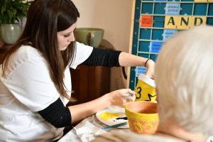 Volunteers painting flowerpots