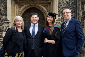 A graduate with her family at the December 2019 UCEM Graduation