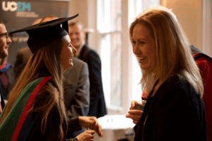 A graduate shares a joke at the December 2019 UCEM Graduation