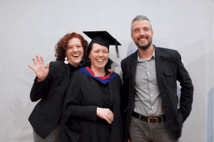 A graduate and friends laughing at the December 2019 UCEM Graduation