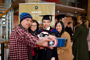 A group pose for a photo at the December 2019 UCEM Graduation