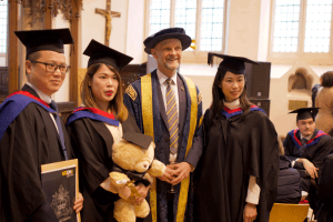 Graduates pose for a photo with UCEM Principal, Ashley Wheaton, at the December 2019 UCEM Graduation