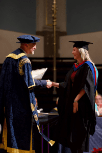 A graduate receives an award at the December 2019 Graduation