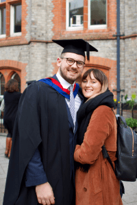 A graduate poses with a friend at the December 2019 Graduation