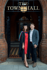 A graduate poses with a friend for a photo at the December 2019 UCEM Graduation