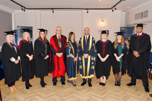 UCEM Vice Chair, Dr Stephen Jackson, Deputy Principal, Jane Fawkes, and Principal, Ashley Wheaton, with postgraduate award winners at the December 2019 UCEM Graduation