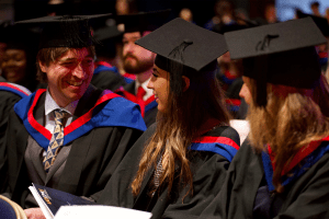 A group of graduands in conversation before the December 2019 UCEM Graduation ceremony