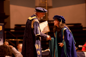 Sherin Aminossehe receives her Honorary Doctorate from UCEM Principal, Ashley Wheaton