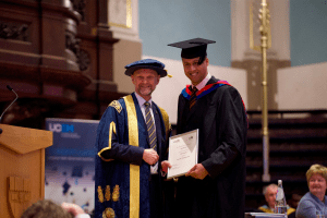 A graduate award winner with UCEM Principal, Ashley Wheaton, at the December 2019 UCEM Graduation