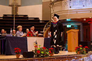 A graduate on stage at the December 2019 UCEM Graduation