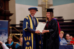 A graduate award winner with UCEM Principal, Ashley Wheaton, at the December 2019 UCEM Graduation